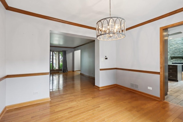 584 Beaconsfield Ave, Naperville, IL 60565 - unfurnished room with ornamental molding, hardwood / wood-style floors, and a chandelier