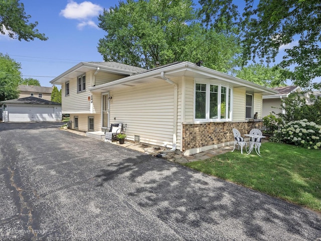 0S544 E St, Winfield, IL 60190 - split level home featuring an outdoor structure, a detached garage, brick siding, and a front yard