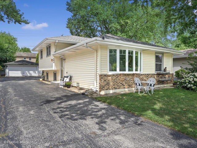 0S544 E St, Winfield, IL 60190 - split level home featuring an outbuilding, brick siding, a garage, and a front lawn