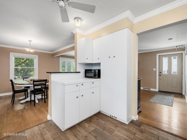 0S544 E St, Winfield, IL 60190 - kitchen featuring black microwave, light wood-type flooring, white cabinetry, crown molding, and a ceiling fan