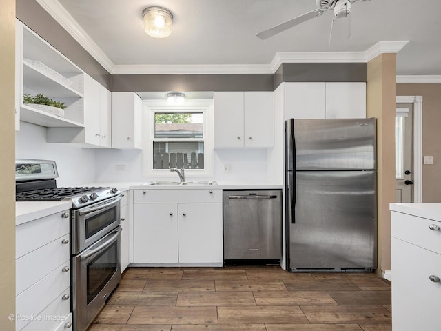 0S544 E St, Winfield, IL 60190 - kitchen featuring stainless steel appliances, crown molding, wood finished floors, white cabinets, and a ceiling fan