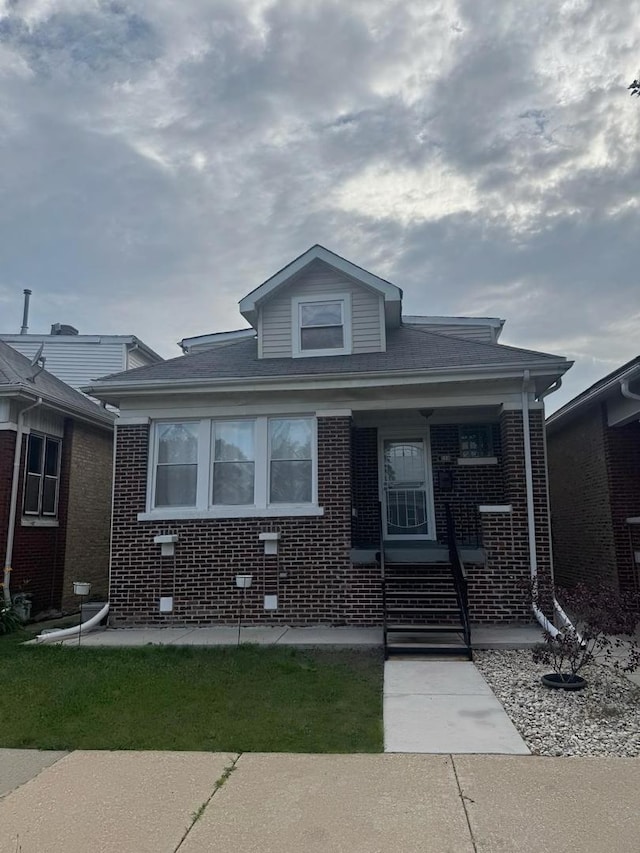 1720 N Major Ave, Chicago, IL 60639 - bungalow with a porch and brick siding