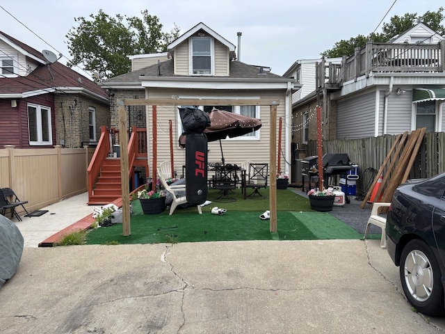 1720 N Major Ave, Chicago, IL 60639 - back of property with a fenced backyard, roof with shingles, and a patio