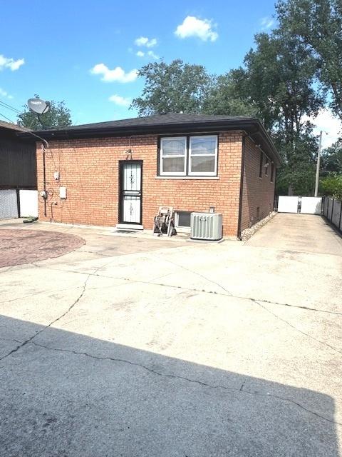 14240 S Manistee Ave, Burnham, IL 60633 - view of front facade with concrete driveway and brick siding