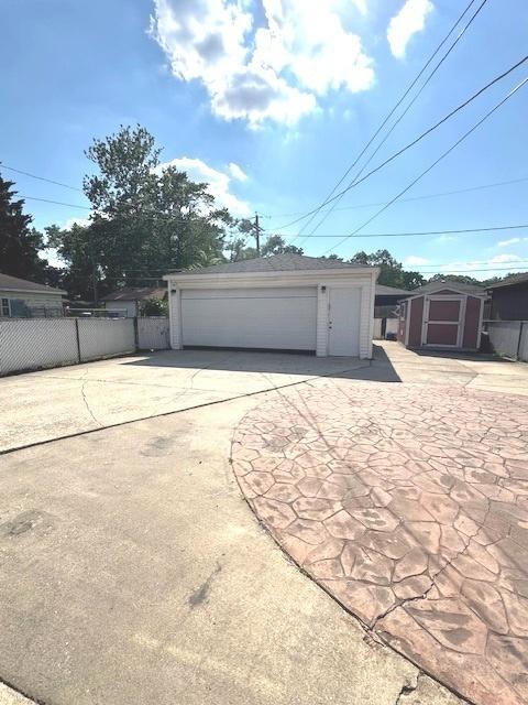 14240 S Manistee Ave, Burnham, IL 60633 - detached garage featuring a storage shed