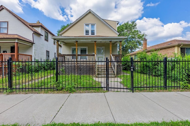 12452 S Eggleston Ave, Chicago, IL 60628 - view of front of house with covered porch, a gate, and a fenced front yard