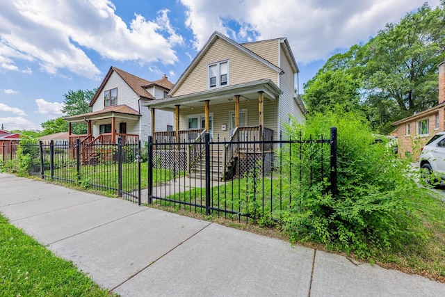 12452 S Eggleston Ave, Chicago, IL 60628 - view of front facade with a porch and a fenced front yard