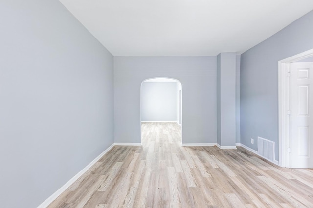 12452 S Eggleston Ave, Chicago, IL 60628 - unfurnished room with arched walkways and light wood-type flooring