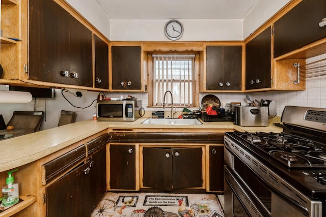 4732 S Lamon Ave, Chicago, IL 60638 - kitchen with appliances with stainless steel finishes, light countertops, decorative backsplash, and dark brown cabinetry