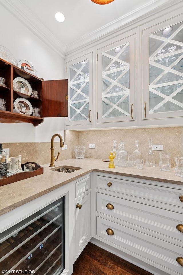 1500 N Lake Shore Dr Unit 5B, Chicago, IL 60610 - indoor wet bar featuring beverage cooler, crown molding, tasteful backsplash, and dark wood-style flooring