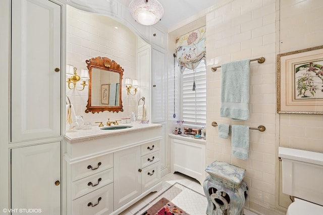 1500 N Lake Shore Dr Unit 5B, Chicago, IL 60610 - bathroom with vanity, tile walls, and tile patterned floors