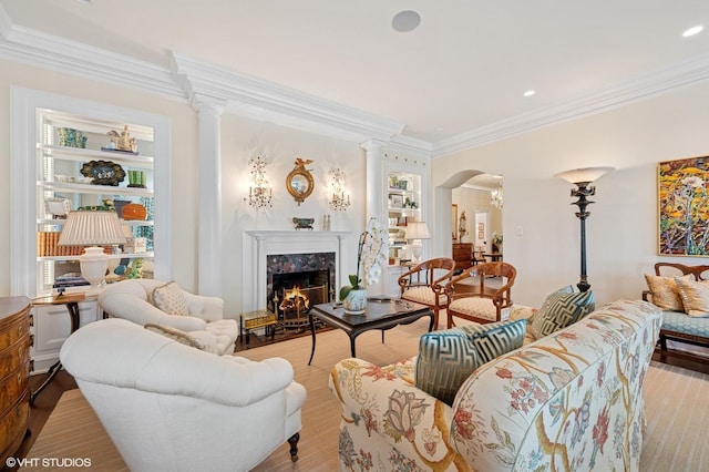 1500 N Lake Shore Dr Unit 5B, Chicago, IL 60610 - living room featuring crown molding, a fireplace, decorative columns, arched walkways, and healthy amount of natural light