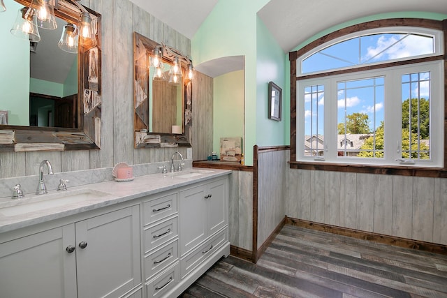 1553 Noble Quest Dr, Bourbonnais, IL 60914 - bathroom with double vanity, wood finished floors, wood walls, a wainscoted wall, and vaulted ceiling