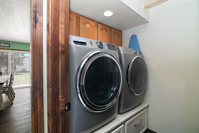 1553 Noble Quest Dr, Bourbonnais, IL 60914 - laundry room featuring a textured ceiling, washing machine and clothes dryer, and cabinet space