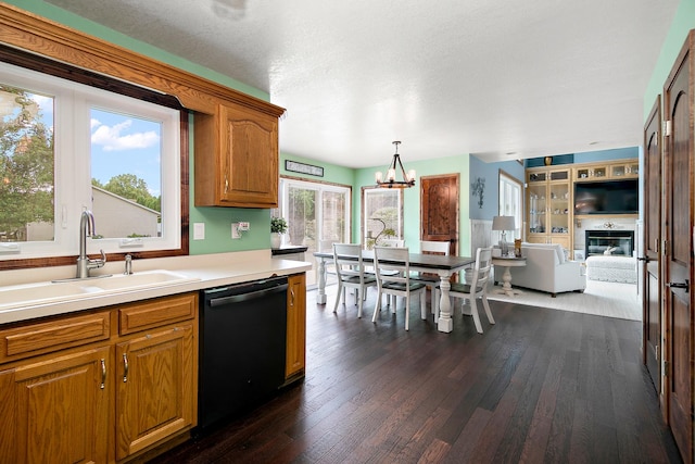 1553 Noble Quest Dr, Bourbonnais, IL 60914 - kitchen featuring dishwasher, a chandelier, dark wood-style flooring, brown cabinets, and light countertops