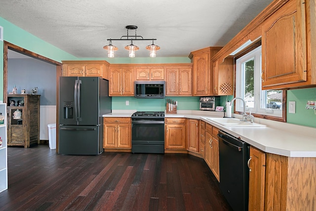 1553 Noble Quest Dr, Bourbonnais, IL 60914 - kitchen with black appliances, dark wood-style floors, light countertops, and pendant lighting