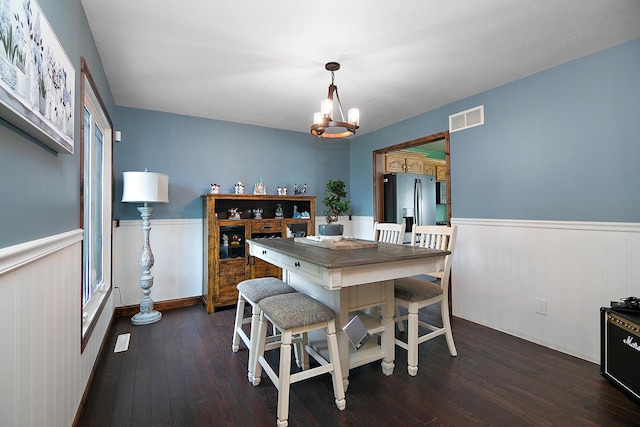 1553 Noble Quest Dr, Bourbonnais, IL 60914 - dining space with a wainscoted wall, dark wood-style floors, and a chandelier