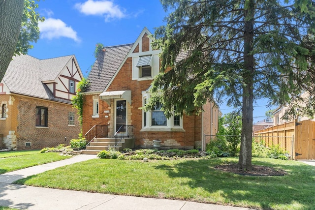 1710 N 74th Ct, Elmwood Park, IL 60707 - tudor-style house with brick siding and roof with shingles