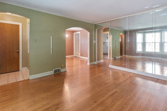 1710 N 74th Ct, Elmwood Park, IL 60707 - unfurnished room with wood finished floors, crown molding, and arched walkways