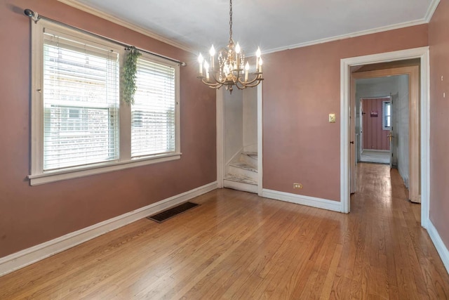 1710 N 74th Ct, Elmwood Park, IL 60707 - unfurnished dining area featuring a chandelier, plenty of natural light, light wood-style flooring, and ornamental molding
