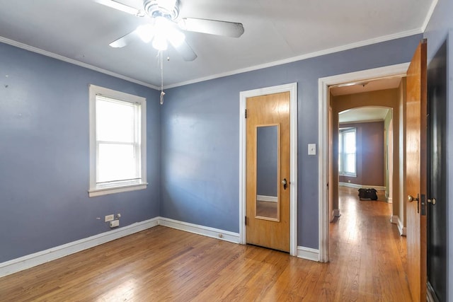 1710 N 74th Ct, Elmwood Park, IL 60707 - unfurnished room featuring arched walkways, hardwood / wood-style floors, ceiling fan, and crown molding