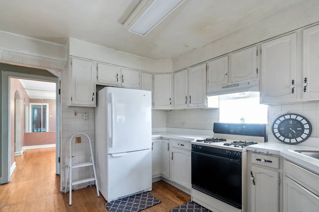 1710 N 74th Ct, Elmwood Park, IL 60707 - kitchen with range with gas cooktop, freestanding refrigerator, under cabinet range hood, and light wood finished floors