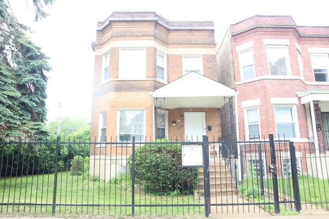 6948 S Eberhart Ave, Chicago, IL 60637 - multi unit property featuring a fenced front yard and brick siding