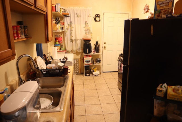 6948 S Eberhart Ave, Chicago, IL 60637 - kitchen with freestanding refrigerator, light tile patterned floors, open shelves, and brown cabinets