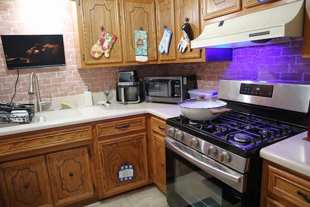 4829 W 109th St Unit 203, Oak Lawn, IL 60453 - kitchen with stainless steel appliances, under cabinet range hood, brown cabinetry, and tasteful backsplash