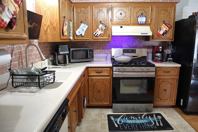 4829 W 109th St Unit 203, Oak Lawn, IL 60453 - kitchen with premium range hood, appliances with stainless steel finishes, brown cabinets, and light countertops