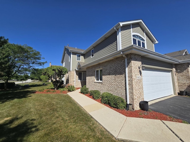8452 Dunmore Dr, Tinley Park, IL 60487 - view of side of property featuring a lawn, an attached garage, brick siding, and asphalt driveway