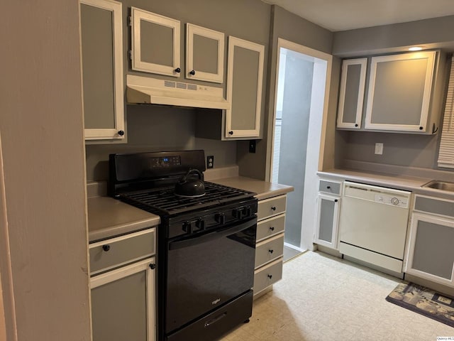 1700 Sycamore, Quincy, IL 62301 - kitchen with black range with gas stovetop, white dishwasher, under cabinet range hood, light countertops, and glass insert cabinets