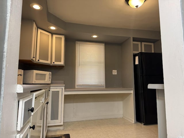 1700 Sycamore, Quincy, IL 62301 - kitchen featuring freestanding refrigerator, white microwave, light flooring, and recessed lighting