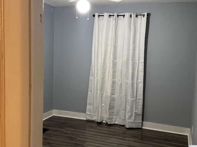 1700 Sycamore, Quincy, IL 62301 - spare room with dark wood finished floors and a textured ceiling