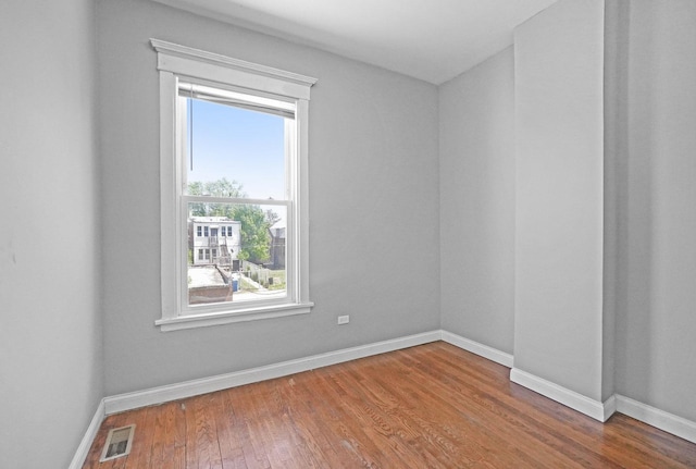 6409 S Champlain Ave, Chicago, IL 60637 - empty room featuring plenty of natural light and wood finished floors