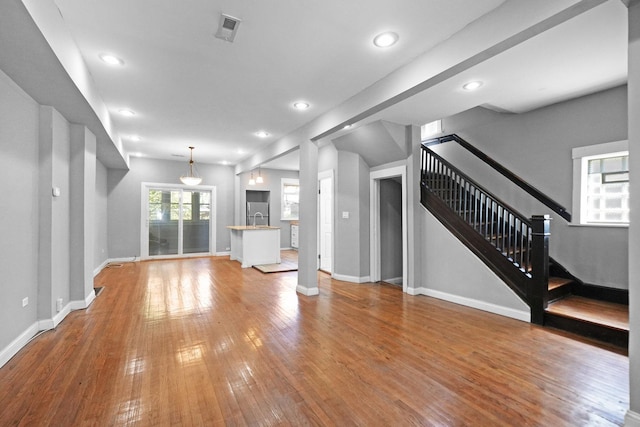 6409 S Champlain Ave, Chicago, IL 60637 - unfurnished living room with hardwood / wood-style floors, recessed lighting, and stairway