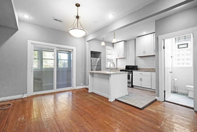 6409 S Champlain Ave, Chicago, IL 60637 - kitchen with appliances with stainless steel finishes, light wood finished floors, white cabinets, tasteful backsplash, and light stone countertops