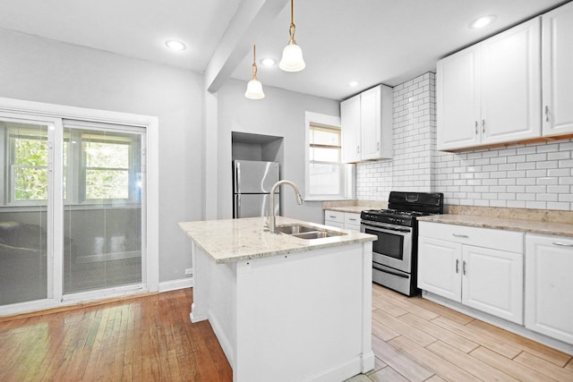 6409 S Champlain Ave, Chicago, IL 60637 - kitchen featuring stainless steel appliances, light wood finished floors, decorative backsplash, white cabinetry, and decorative light fixtures