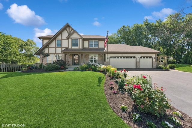 1885 Mcrae Ln, Mundelein, IL 60060 - tudor house featuring a garage, driveway, stone siding, stucco siding, and covered porch