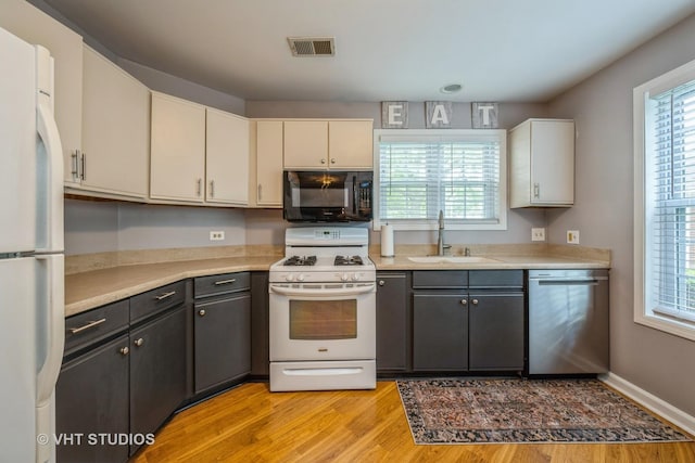 285 Sheffield Dr, Schaumburg, IL 60194 - kitchen with white appliances, light wood-style floors, light countertops, and plenty of natural light
