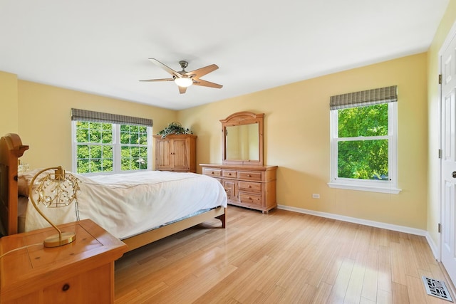 920 Matthew Ct, Naperville, IL 60540 - bedroom with multiple windows, light wood-style flooring, and ceiling fan