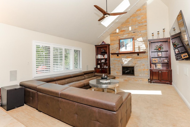 560 81st St, Burr Ridge, IL 60527 - living room with ceiling fan, high vaulted ceiling, a stone fireplace, a skylight, and light colored carpet