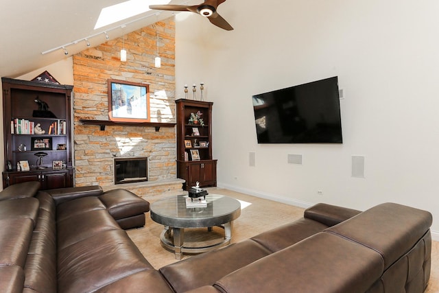 560 81st St, Burr Ridge, IL 60527 - living area featuring ceiling fan, a skylight, rail lighting, a fireplace, and light carpet