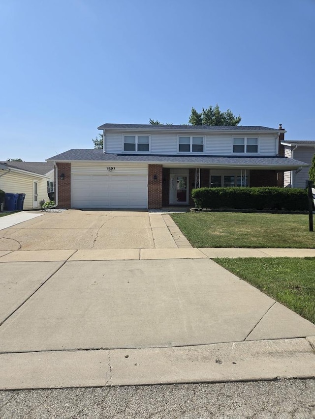 1807 W Locust Ln, Mount Prospect, IL 60056 - traditional home featuring concrete driveway, brick siding, a front yard, and an attached garage