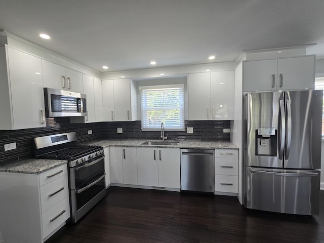 1807 W Locust Ln, Mount Prospect, IL 60056 - kitchen featuring appliances with stainless steel finishes, light stone counters, white cabinetry, dark wood finished floors, and decorative backsplash