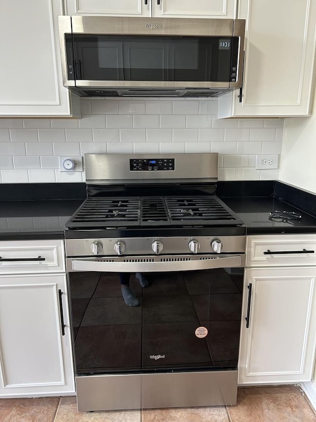 6220 Misty Pines Dr Unit 3, Tinley Park, IL 60477 - kitchen featuring appliances with stainless steel finishes, dark countertops, and white cabinets
