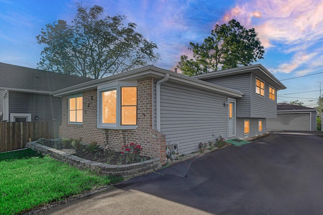 26W278 Harrison Ave, Winfield, IL 60190 - property exterior at dusk with brick siding, an outbuilding, and a detached garage