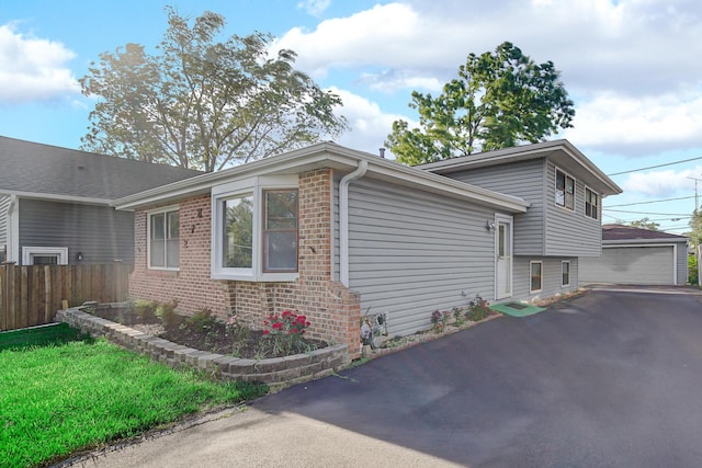 26W278 Harrison Ave, Winfield, IL 60190 - view of side of home featuring brick siding, a detached garage, and an outbuilding