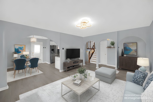 26W278 Harrison Ave, Winfield, IL 60190 - living area featuring arched walkways, wood finished floors, and stairway