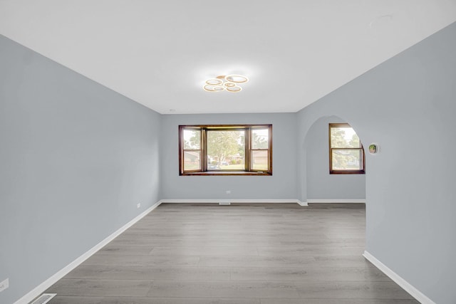 26W278 Harrison Ave, Winfield, IL 60190 - spare room with wood finished floors and arched walkways